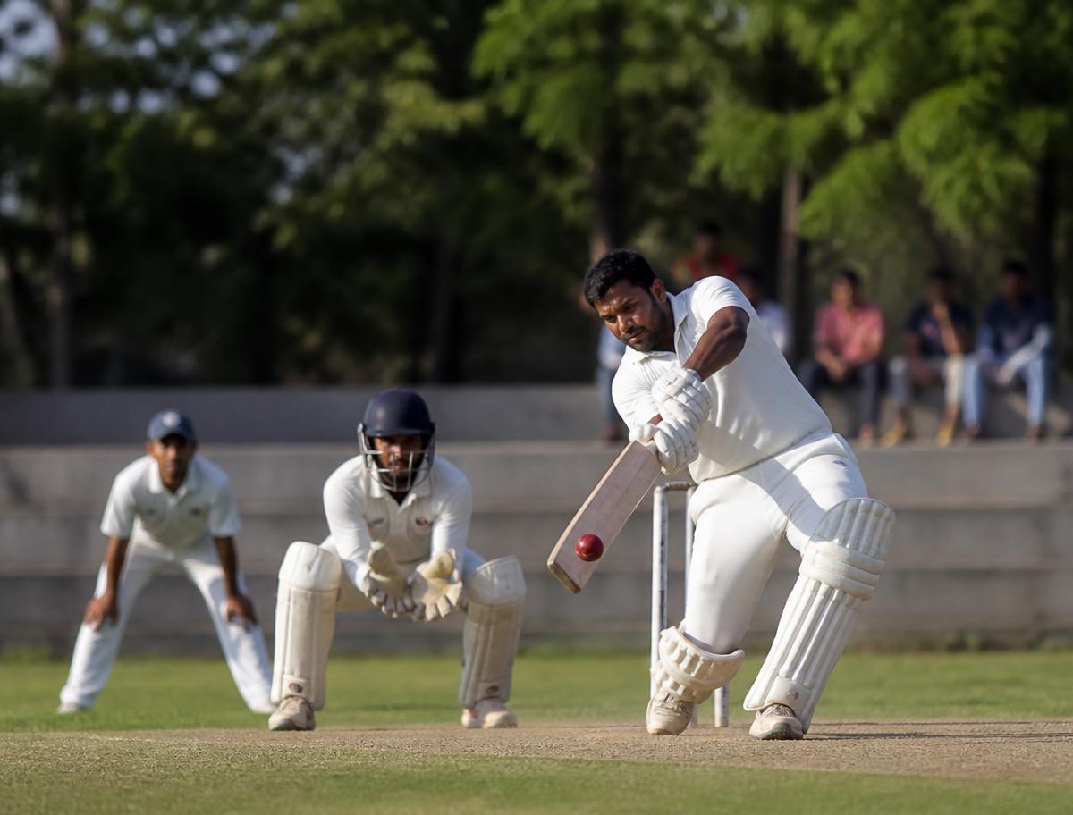 Batsman driving through the covers during a weekend cricket match at a Chennai cricket venue