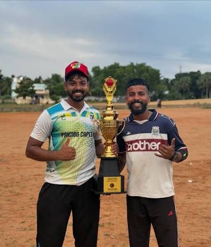 Two players holding the champions trophy after a SuperCounty one day cricket tournament in Chennai